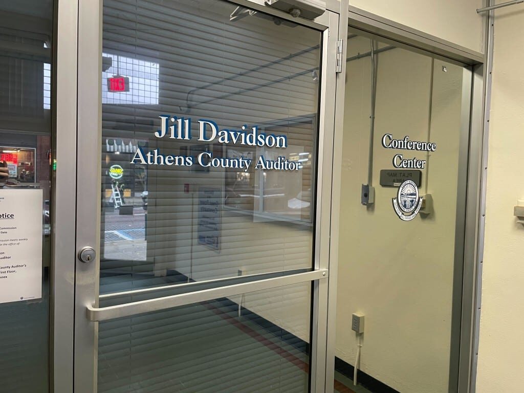 Text over a glass door, "Jill Davidson / Athens County Auditor".