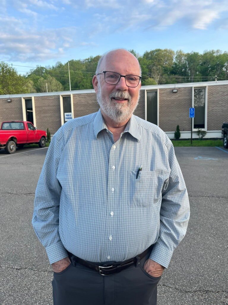 A man smiles before Nelsonville City Hall.