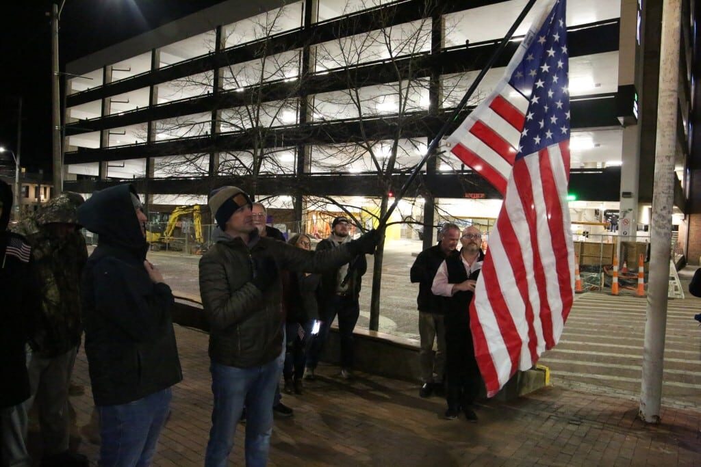 Men saying the Pledge of Allegiance. 