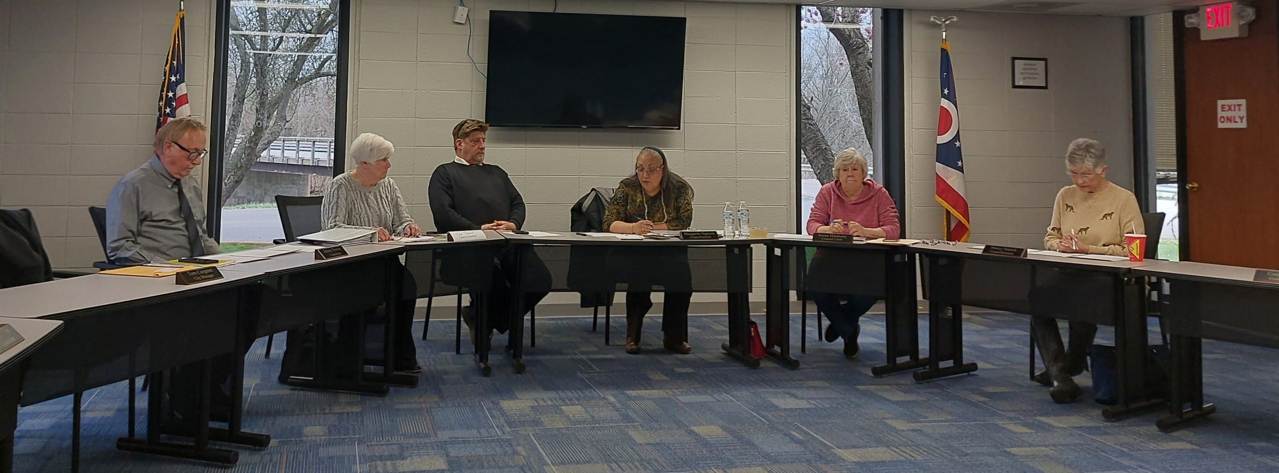 Six people sit seated in council chambers. Left to right: council member Johnny Flowers, member Sue Powell, city attorney Mathew Voltolini, member Rita Nguyen, clerk of council Susan Harmony, council vice president Nancy Sonick.