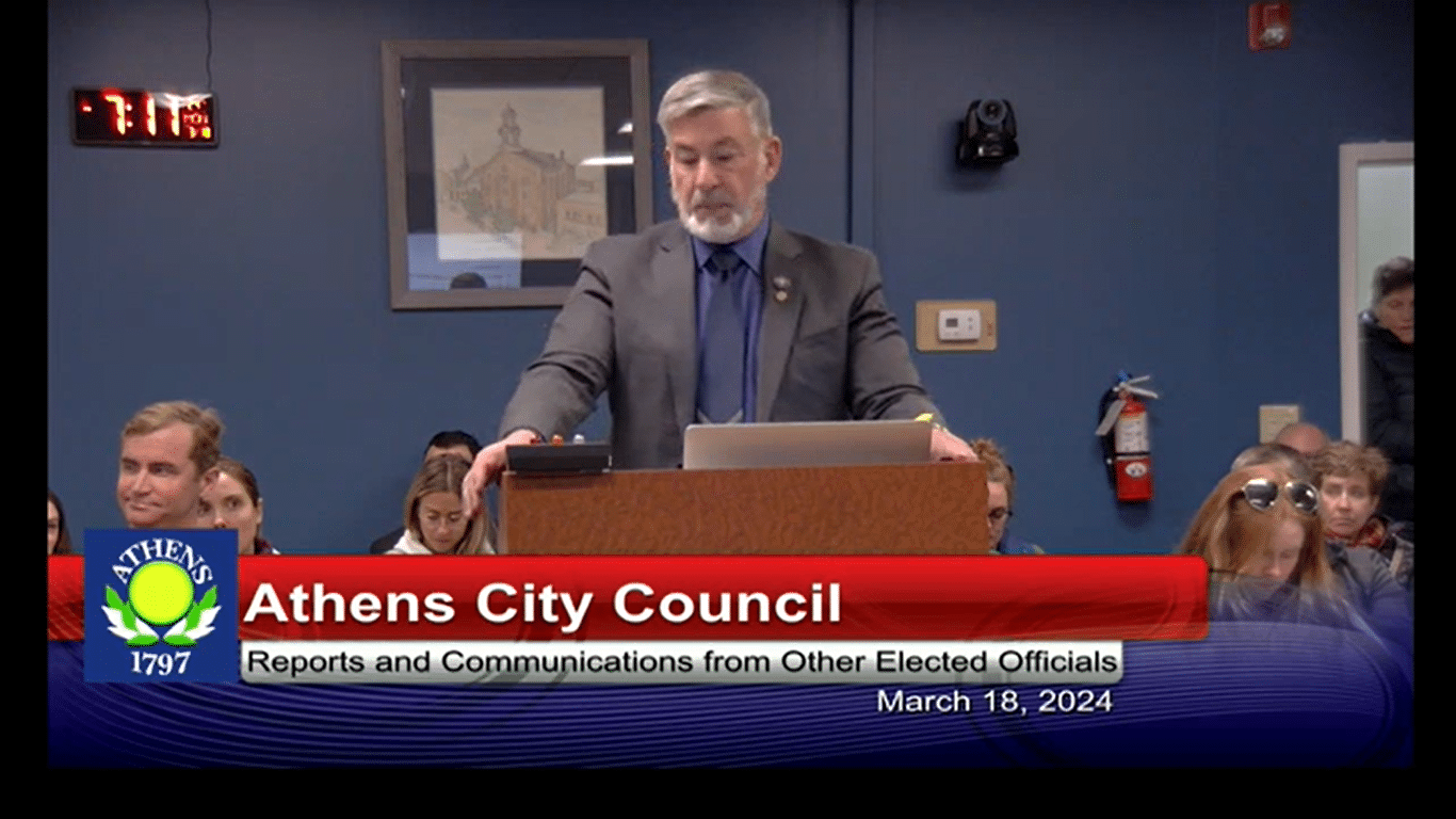 Steve Patterson stands talking at a podium.