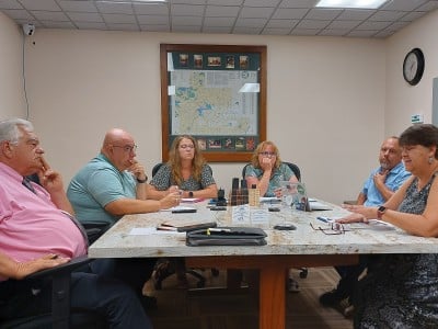 Six people sit at a table.