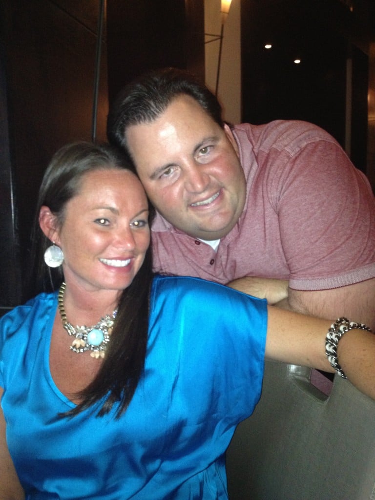 A woman and man pose for a picture together, smiling.