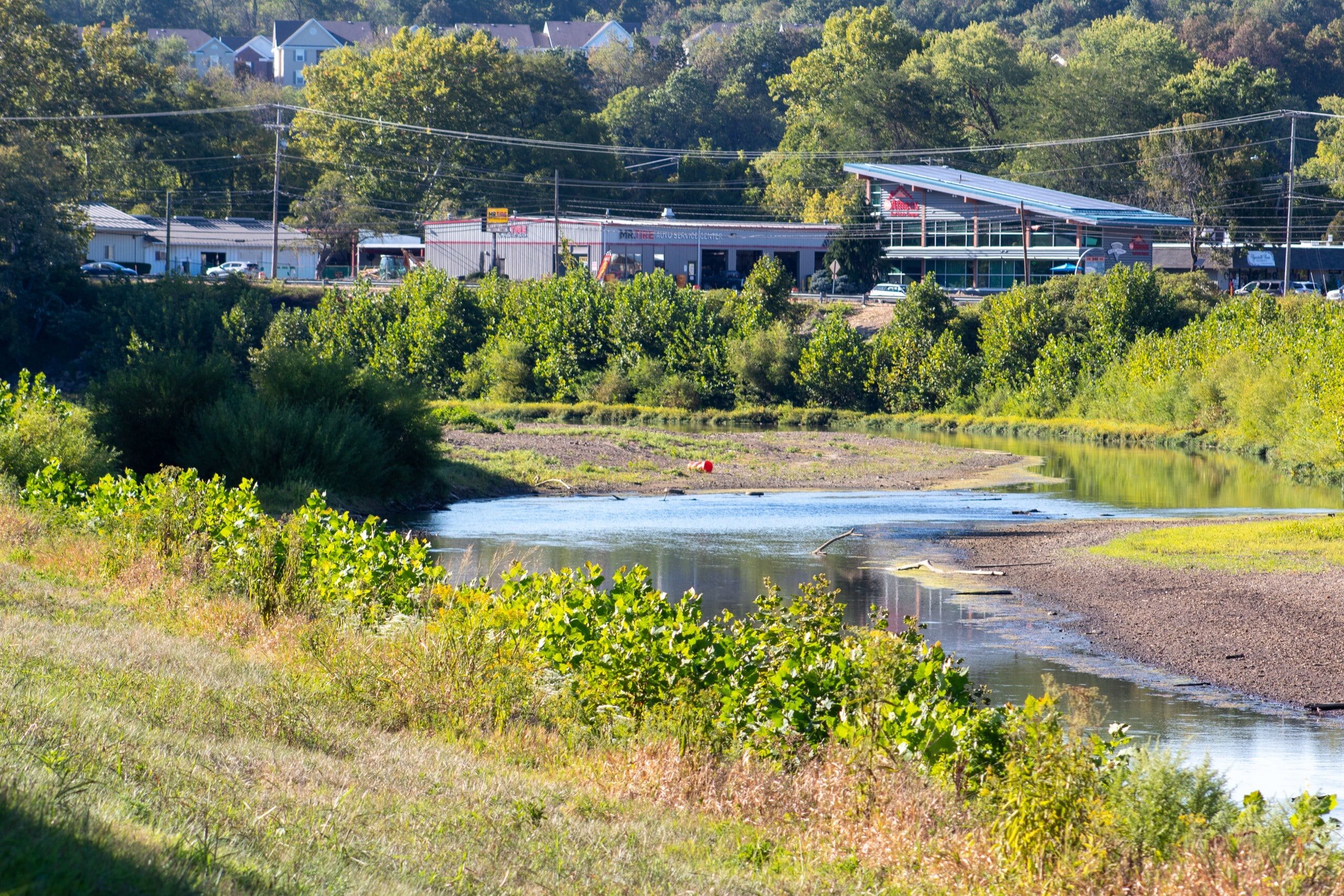 A view of the Hocking River, running low, from atop a river bank.