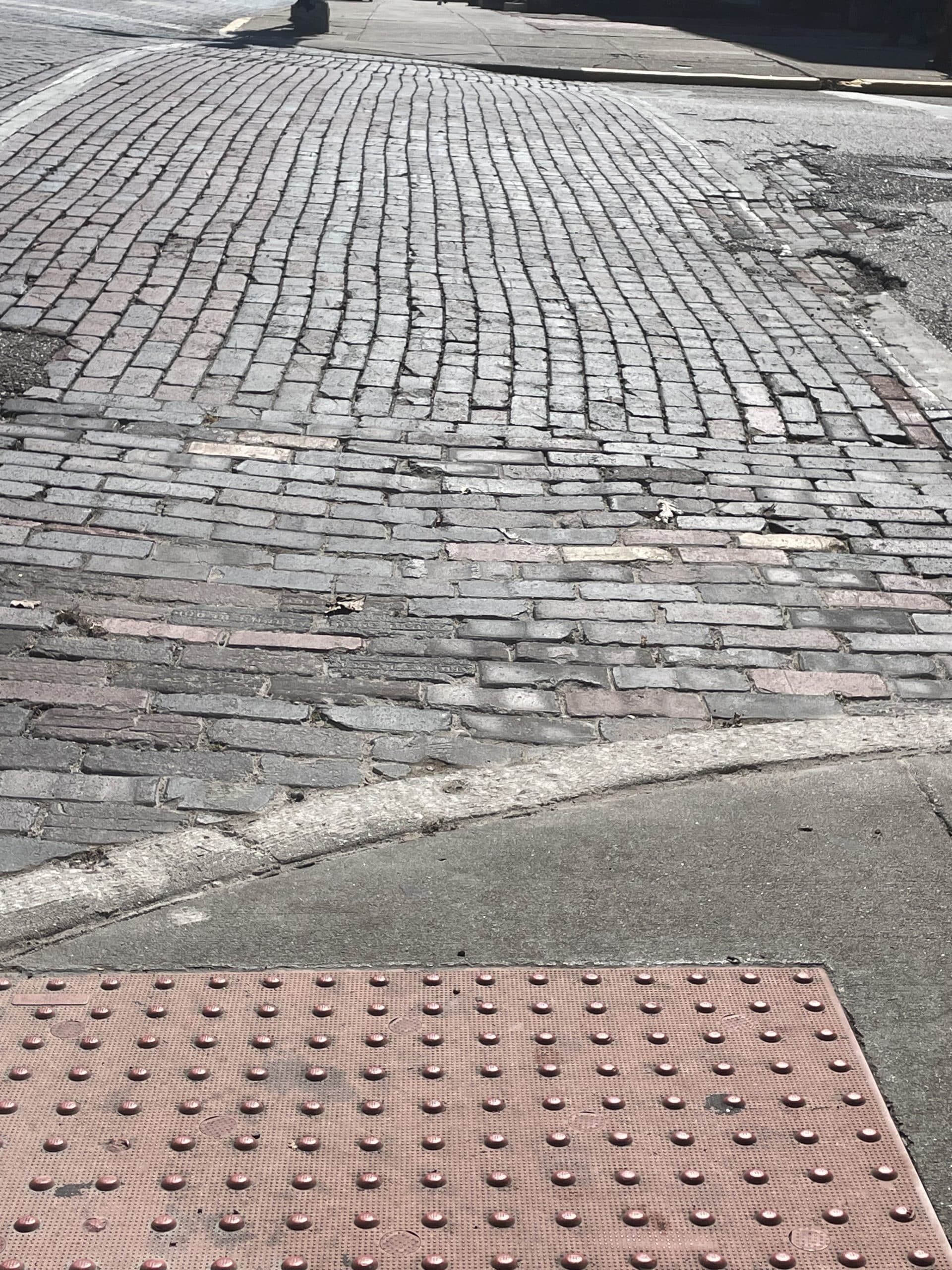 uncut curb on brick street uptown