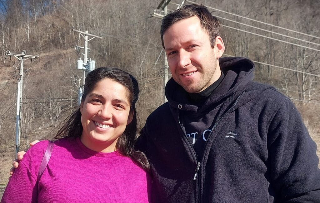 Two people smile for a photo.