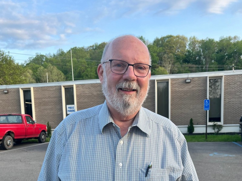 A man smiles before Nelsonville City Hall.