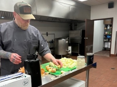 Chef at 740 Kitchen cuts vegetables