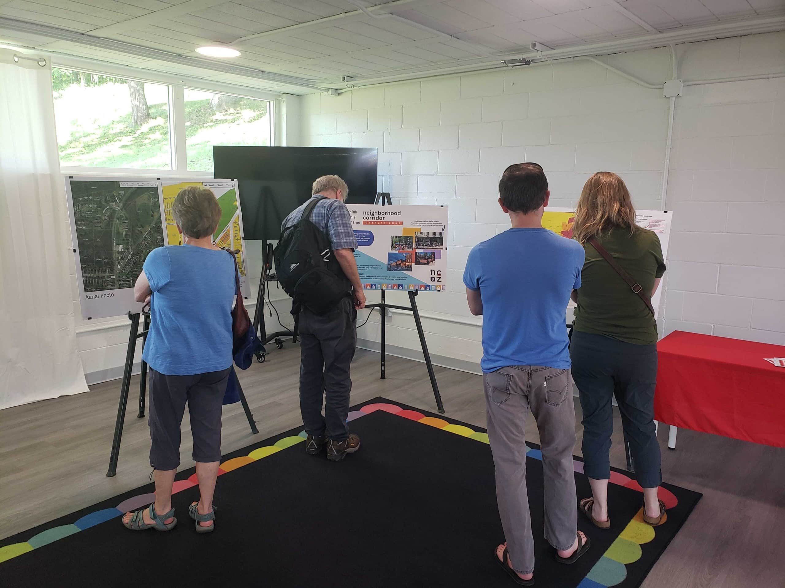 Attendees review a display set up at the Athens City Planning Commission meeting
