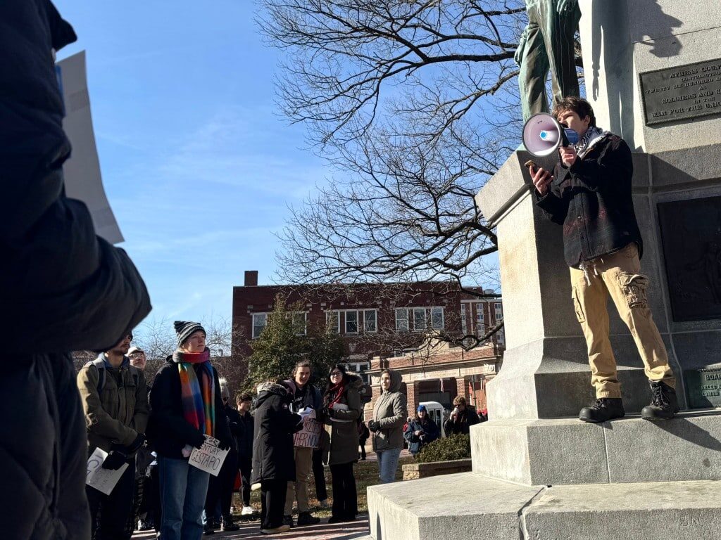 Henry, a member of Students for Justice in Palestine, speaks to the crowd from atop the Soldiers and Sailors Monument on Ohio University’s College Green
