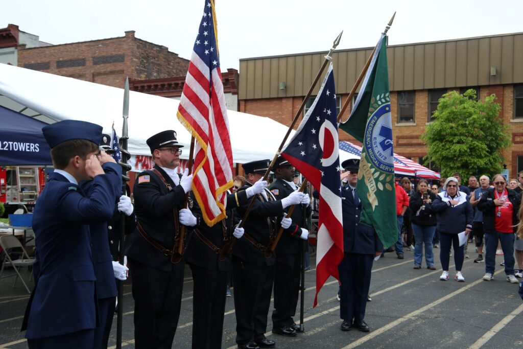 The honor guard at the 2026 Tunnels to Towers in Nelsonville. They carry the Ohio flag, the American flag and an EMS honor guard flag.