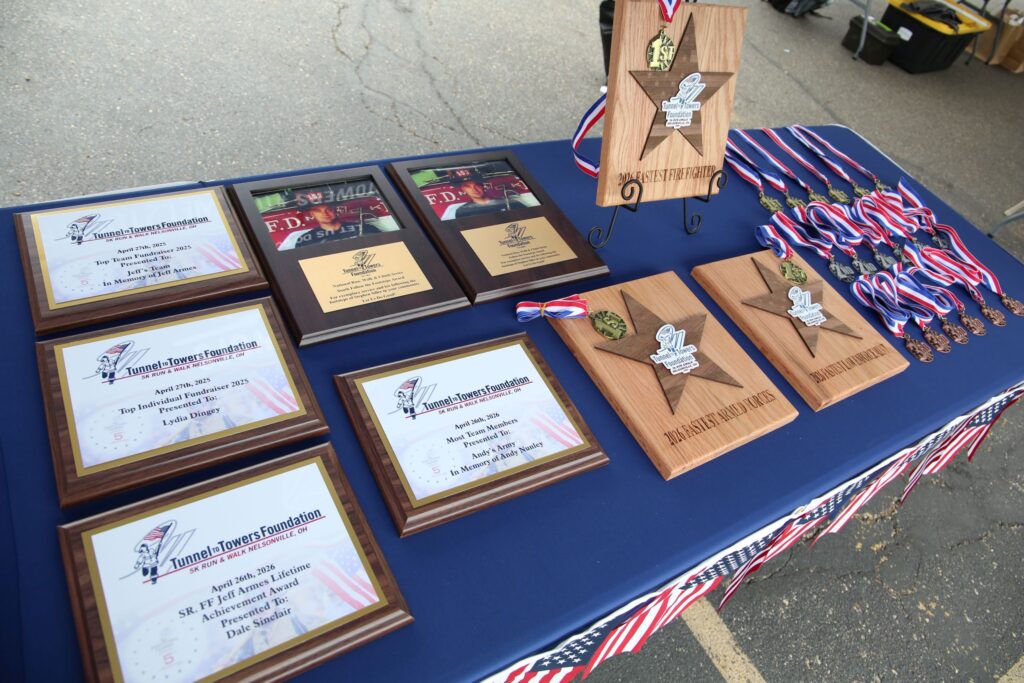A table full of plaques and medals.