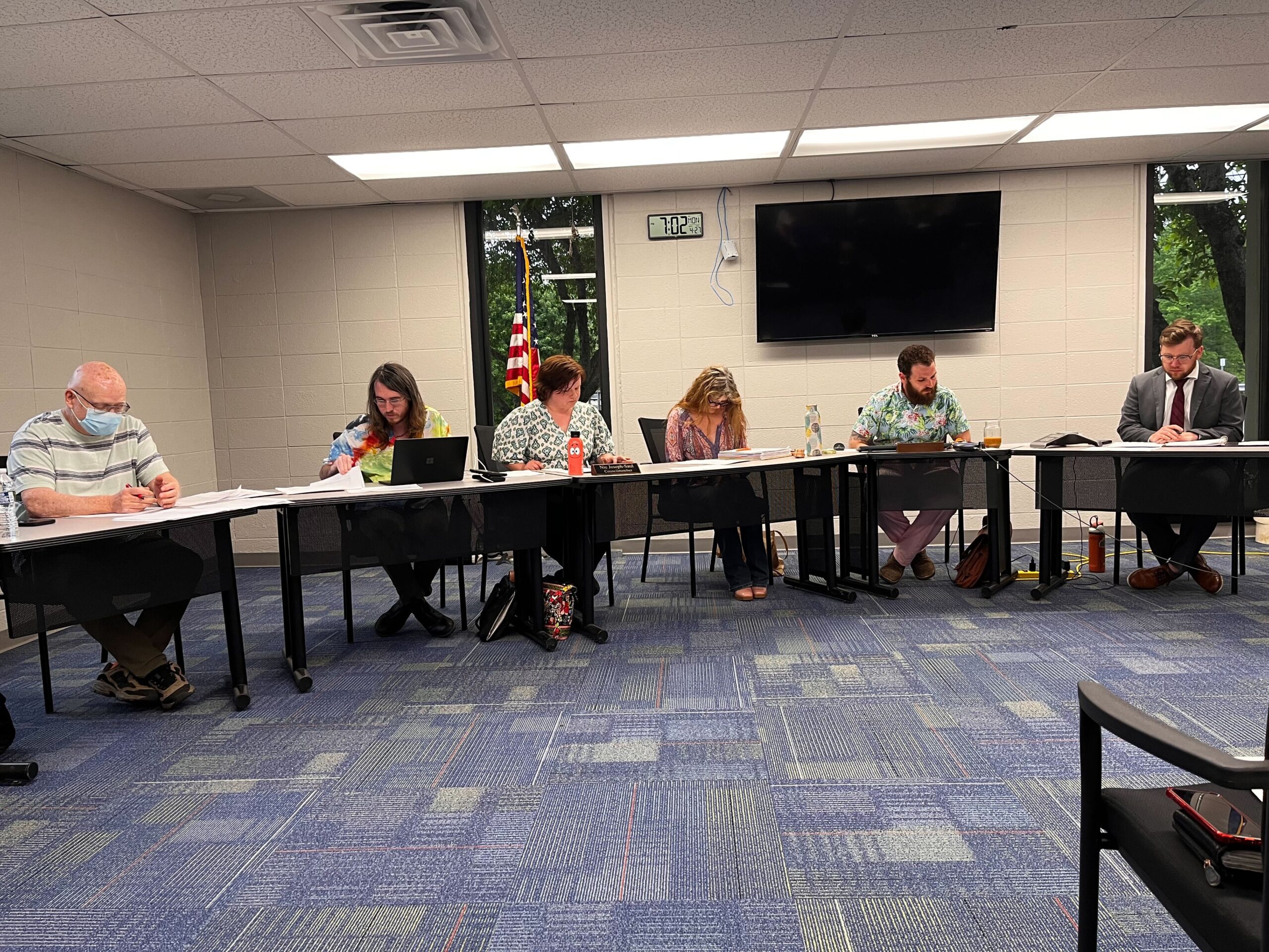 Nelsonville City Council meeting behind tables.