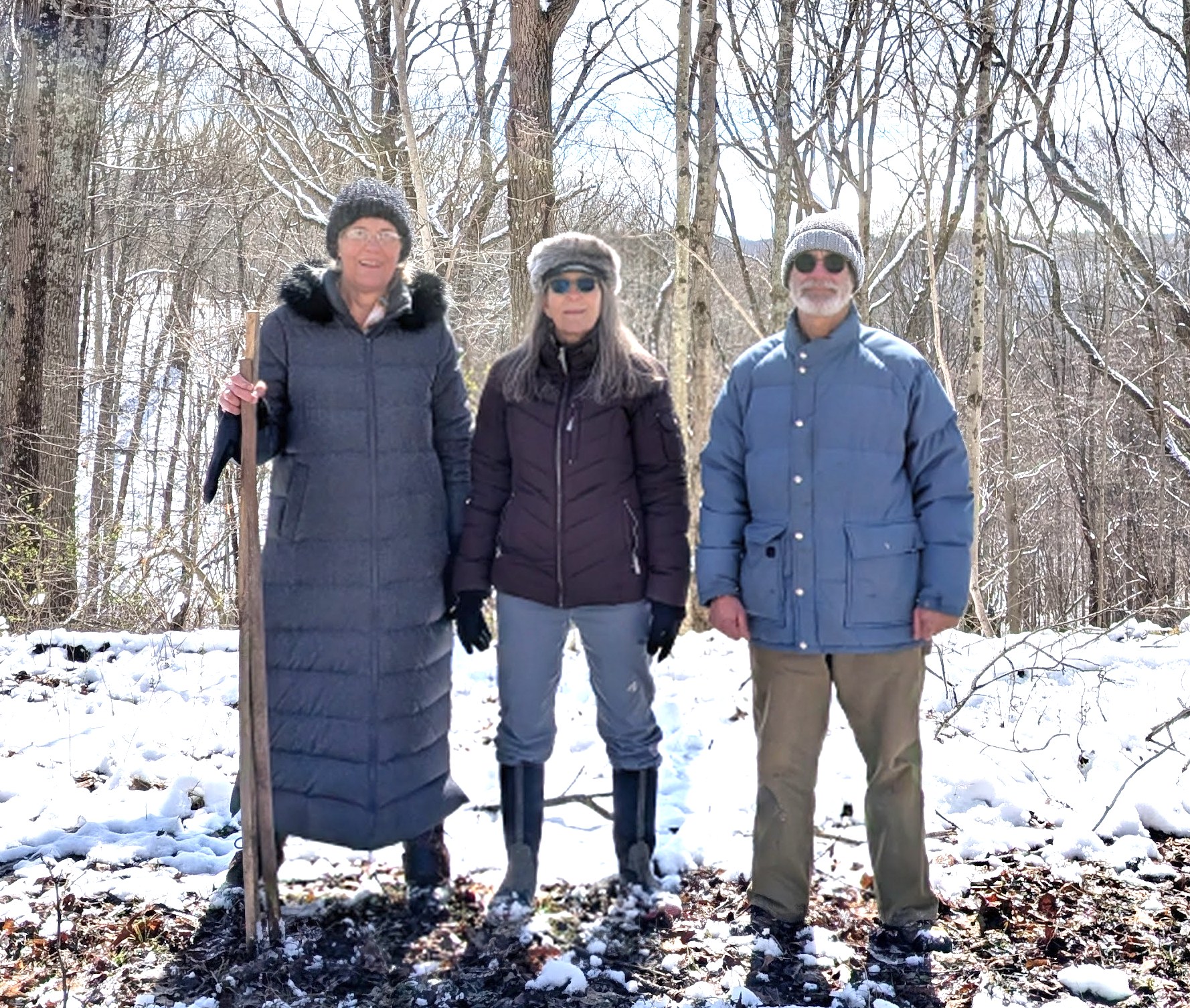 Three people standing in the snow