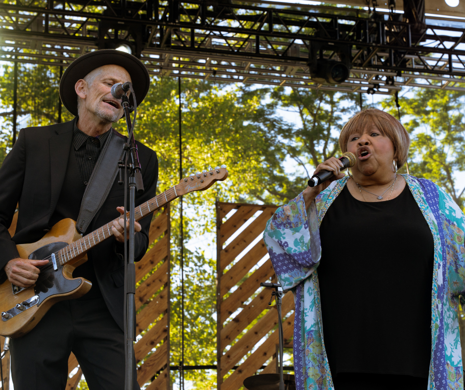 A guitarist and Mavis Staples performing.