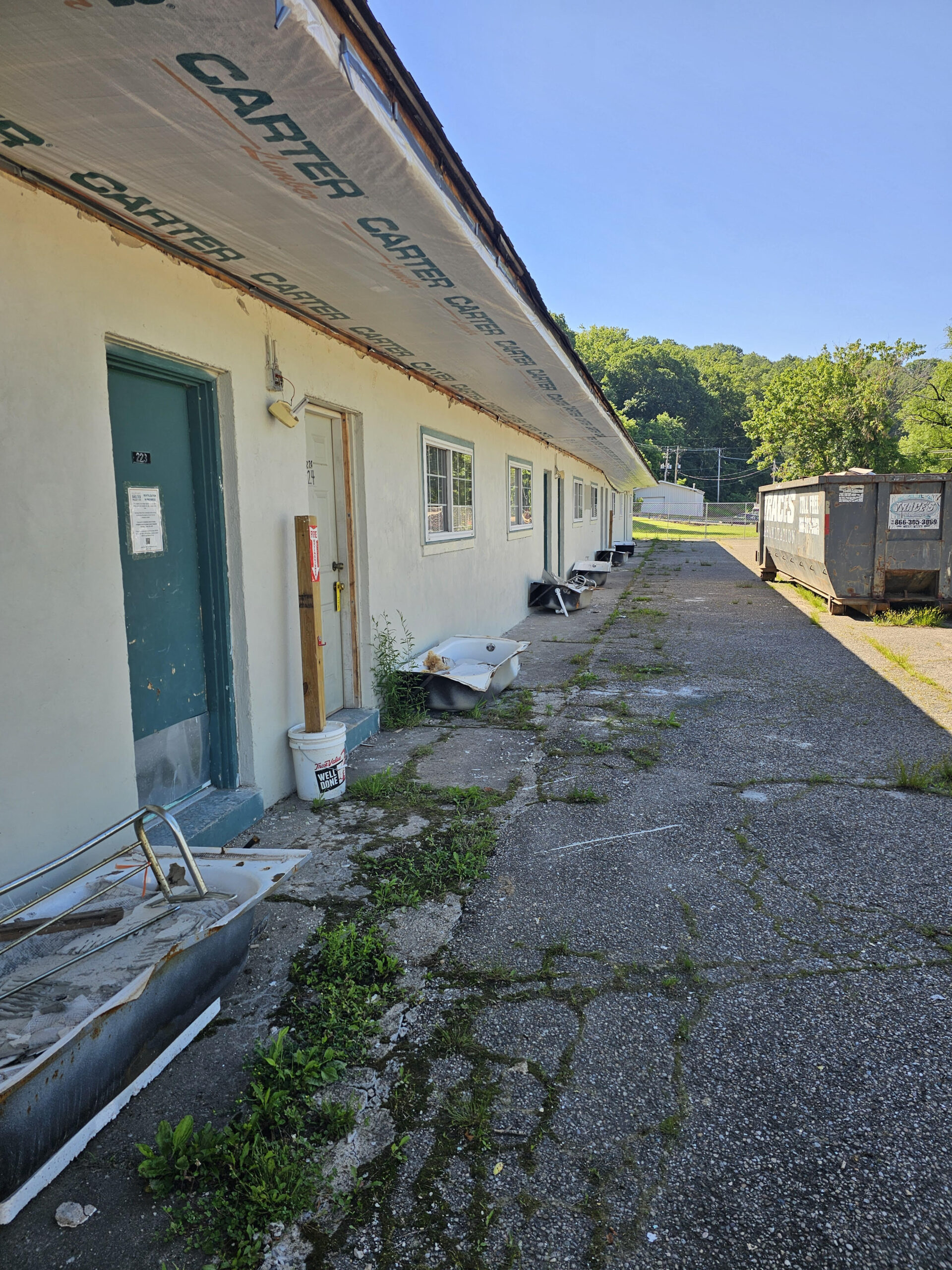Exterior of Sunset Shelter, construction and dumpster.