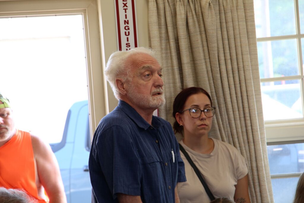 A older man speaking