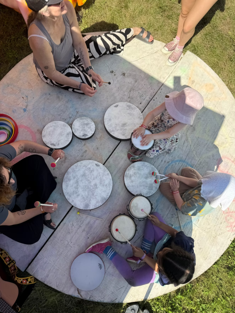 Children drumming in a circle