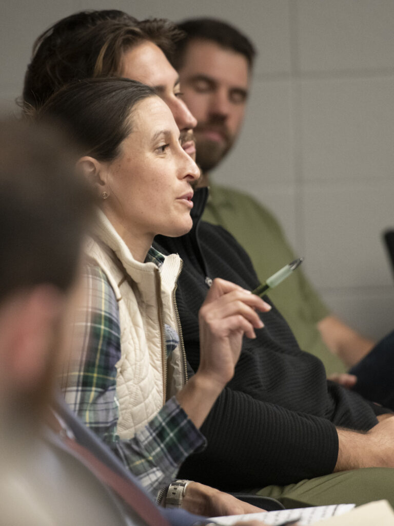 Claire Green speaking, holding a pen.