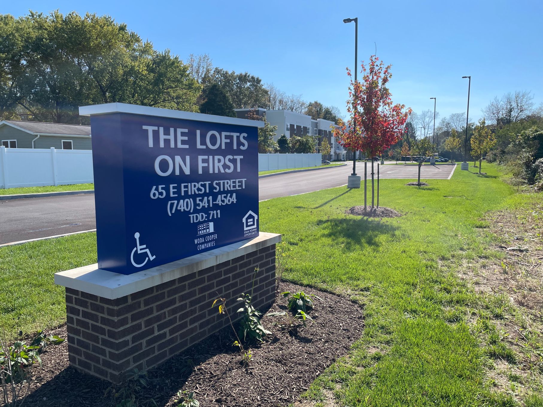 A blue sign for The Logs on First, at 65 E. First St. in The Plains.